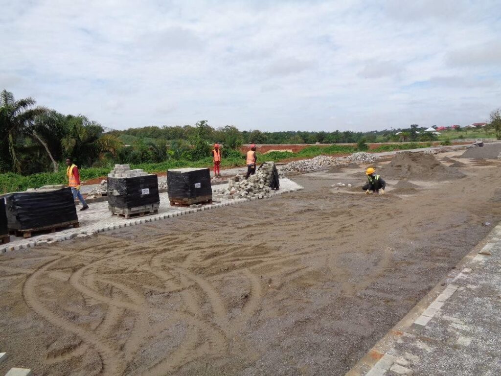 Crew preparing a road surface ahead of bitumen application