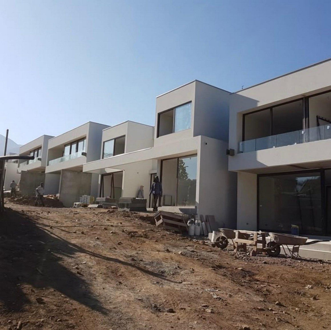 Townhouse development at finishing stage with scaffolding and external works underway