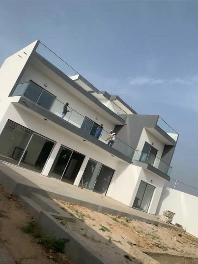 Exterior finishing works including balconies and railings on a villa